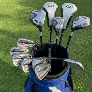 A complete set of youth left handed golf clubs neatly arranged in a golf bag.
