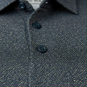 Detailed view of the pattern and texture of patterned greg norman golf shirts.