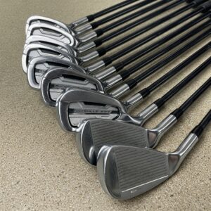 A set of men's left-handed golf irons, showcasing various club numbers from pitching wedge to long irons, essential for any set of mens left hand golf clubs.