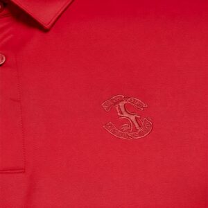 Detail of a logo on a high-quality red golf shirt.