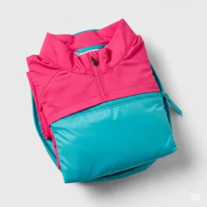 Image of a lightweight womens golf jacket neatly folded and packed into a small pouch, demonstrating its packability.