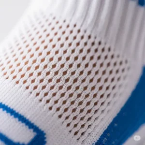 A close-up texture shot of the breathable, mesh fabric on the top of a womens golf sock, designed for ventilation during a game.