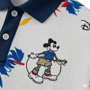 Close-up shot of a Disney golf polo, highlighting the detailed fabric and embroidered Mickey Mouse logo.