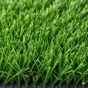 Close-up view of the durable synthetic grass fibers on a golf turf mat for home practice.
